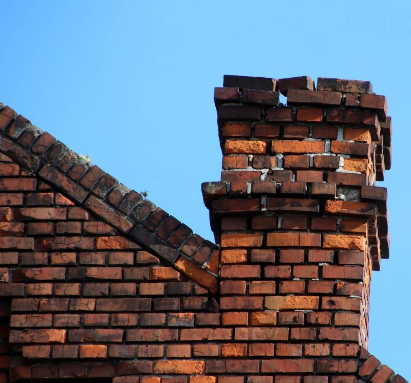Damaged chimney on an Hometown home showing cracks and missing mortar
